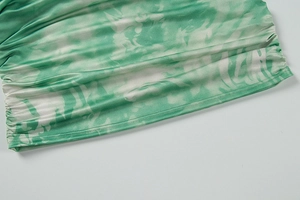 Detail of green and white marble tie-dye bikini side with ruched fabric and fine stitching