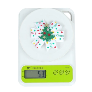 Christmas bow hair clip weighing 5.3g featuring festive prints and a green tree icon