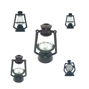 Detailed macro view of five miniature black plastic oil lamp models for dollhouses