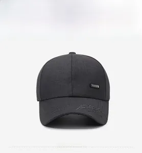 Detail of dark grey baseball cap featuring streamline embroidery and fashion label