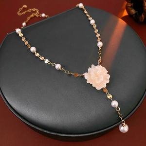 French floral pearl necklace with gold chain on display, elegant fashion jewelry for women
