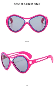Detail view showing front and side profile of rose red heart-shaped oversized sunglasses