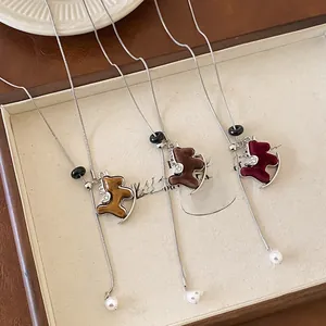 Detail of velvet pony sweater necklaces with pearls and adjustable sliding beads