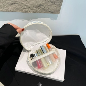 Internal mesh pocket and white lining detail of a cylindrical floral cotton makeup bag