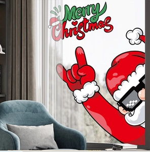 Macro detail of Santa Claus window sticker with Merry Christmas text on a home background