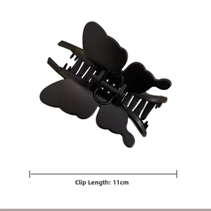 Macro detail of 11cm large butterfly hair claw clip with matte black finish and strong spring