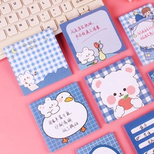 Macro shot of assorted blue cartoon sticky notes featuring cute bear and goose designs
