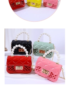 Detail of mini jelly bags with faux pearl handles, metal chains, and hollowed-out patterns