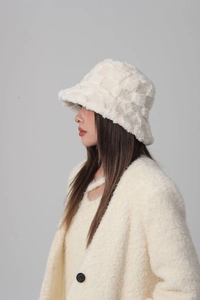 Detailed texture of white plush fisherman hat made of high-quality faux fur fabric
