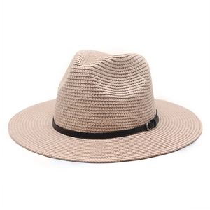 Detail of light beige straw fedora with fine texture and black leather band with silver buckle