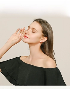 Close-up of elegant light blue star earrings worn by a model in a minimalist style