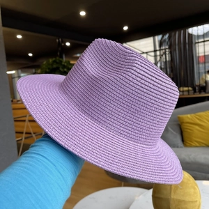 Detailed weave of a light purple straw fedora hat with a classic creased crown