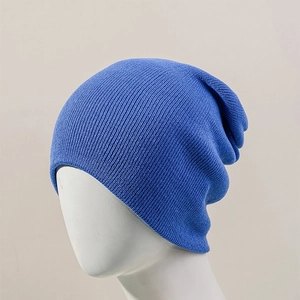 Detailed view of dark blue slouchy beanie showing the fine vertical knit texture on a model