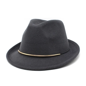 Detailed close-up of dark grey wool fedora hat featuring a gold curved metal buckle accent