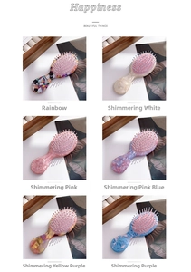 Detail of colorful acetate handle paddle hairbrushes with pink massage pins