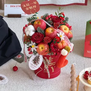 Christmas bouquet flower bucket with red roses, apples, and gold Merry lettering