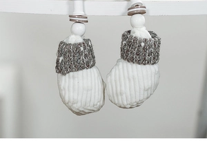 Close-up of knit Christmas boot ornaments with corduroy, wooden beads and button details