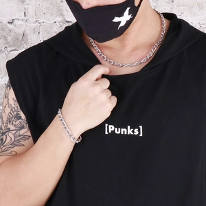 Street style view of a 7mm silver curb chain necklace and bracelet set on a model