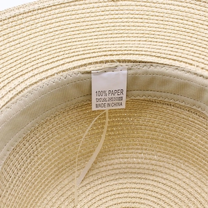 Macro detail of the 100% paper material woven texture and inner care label of the hat