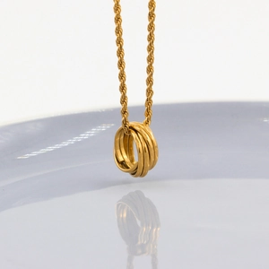 Minimalist gold stainless steel necklace with three interlocking circular rings on rope chain