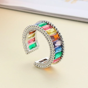 Macro detail of silver open ring featuring rainbow baguette zircons and beaded edge texture