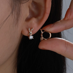 Close-up of rose gold rabbit hoop earrings with sparkling cubic zirconia crystals
