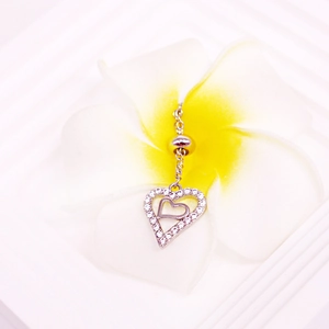 Silver stainless steel heart nipple ring with clear zircons on a white flower