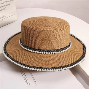 Brown woven straw sun hat with elegant pearl ribbon detail and flat top design