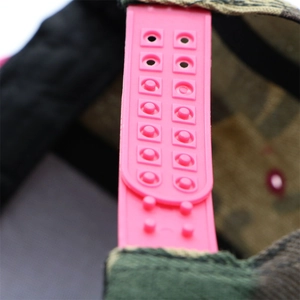 Detail of pink plastic snapback closure on a camouflage flat brim hip hop baseball cap