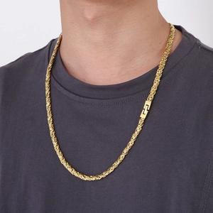Detail of a gold braided rope chain necklace featuring a unique square buckle on model