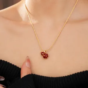 Elegant 18k gold plated necklace featuring a red gourd pendant with gold dots