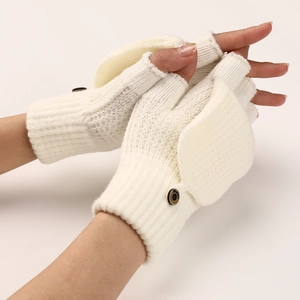 Detail of cream-white knitted fingerless gloves with a flip top and fashion button