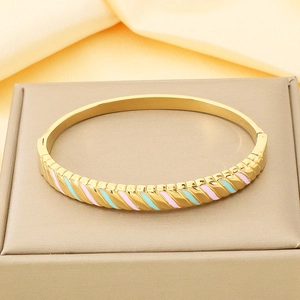 Detailed close-up of 18K gold plated LONE letter bracelet with blue and pink enamel on silk