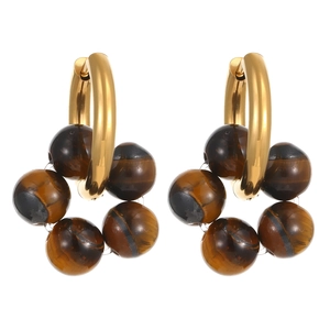 Detail view of gold hoop earrings with polished tiger eye stone beads on a white background