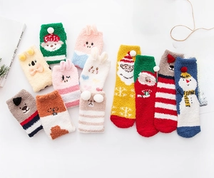 Detail of Christmas coral fleece socks featuring cartoon 3D patterns like reindeer and Santa