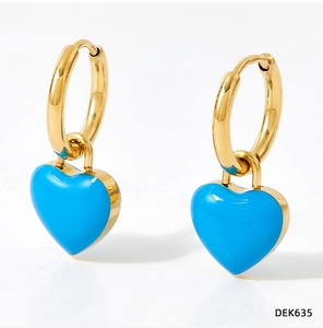 Close-up of golden hoop earrings featuring glossy blue enamel heart-shaped charms