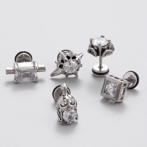 Macro shot of vintage style silver ear studs set with cubic zirconia in assorted shapes