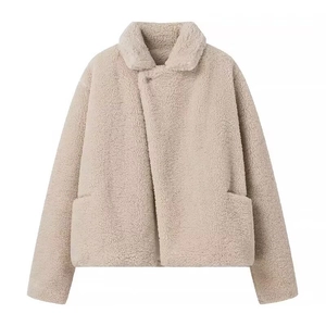 Detailed view of beige faux shearling jacket with lapel collar and diagonal closure