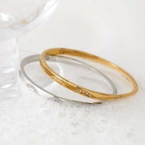 Elegant gold and silver wavy stainless steel bangles with sparkling zircon accents