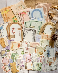 Vintage scrapbooking sticker set with antique labels and floral patterns on wood surface