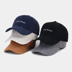 Detailed pile of corduroy baseball caps with 'baba' embroidery in five various colors