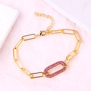 Detail of gold-plated link bracelet with pink gemstone oval charm and lobster clasp