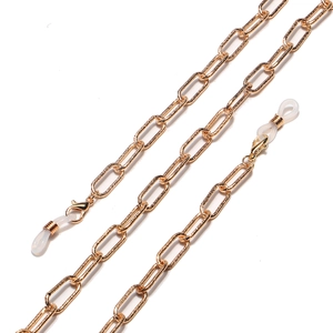 Macro view of gold metal chain links with lobster clasp and silicone anti-slip rings