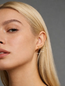 Detail view of 6mm to 9mm gold s925 silver hoop earrings on ear for size comparison