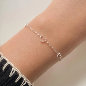 Elegant 925 sterling silver chain bracelet featuring hollow heart-shaped charms for women
