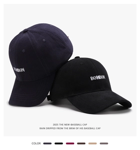 Detail of navy and black cotton baseball caps with BOMBON letter embroidery and curved brims