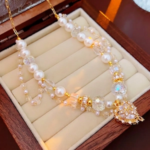 Double-layered pearl and crystal necklace with a vintage diamond-set heart pendant