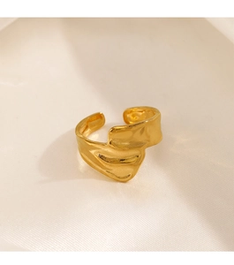 Detailed view of the 18K gold plated textured wavy ring on silk fabric background