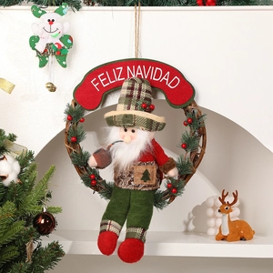 Christmas wreath with plush dolls and Feliz Navidad sign for holiday door decoration