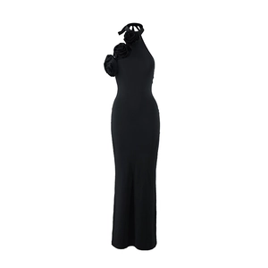 Detail of elegant black halter maxi dress featuring 3D floral accents on shoulder